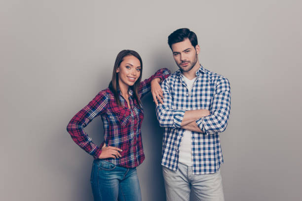 Portrait of two nice lovely attractive cheerful people married spouses husband wife wearing checked shirt girl leaning on guy isolated over gray pastel background